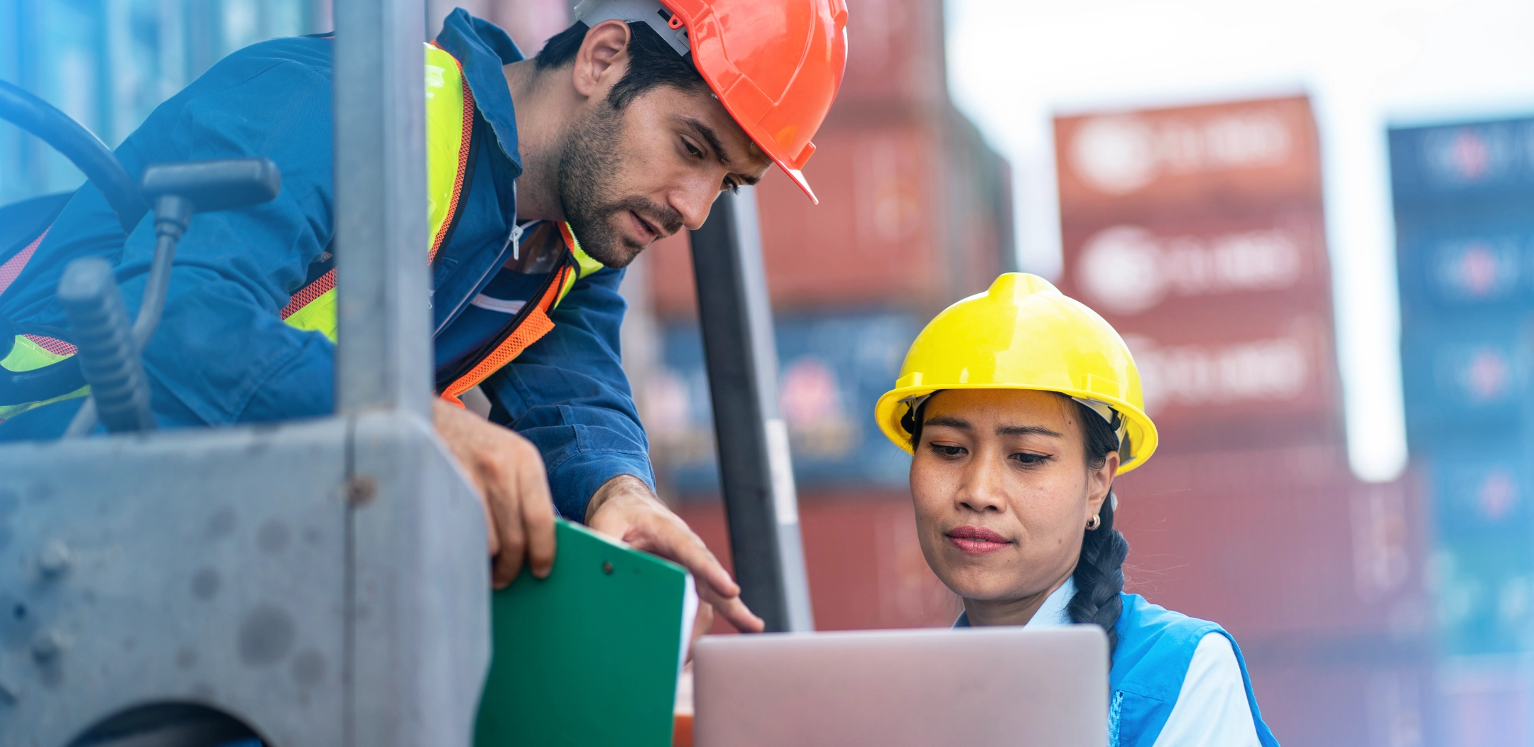 Logistics workers looking at a tablet together, evaluating their current accounting system as they consider if it’s time for a change.