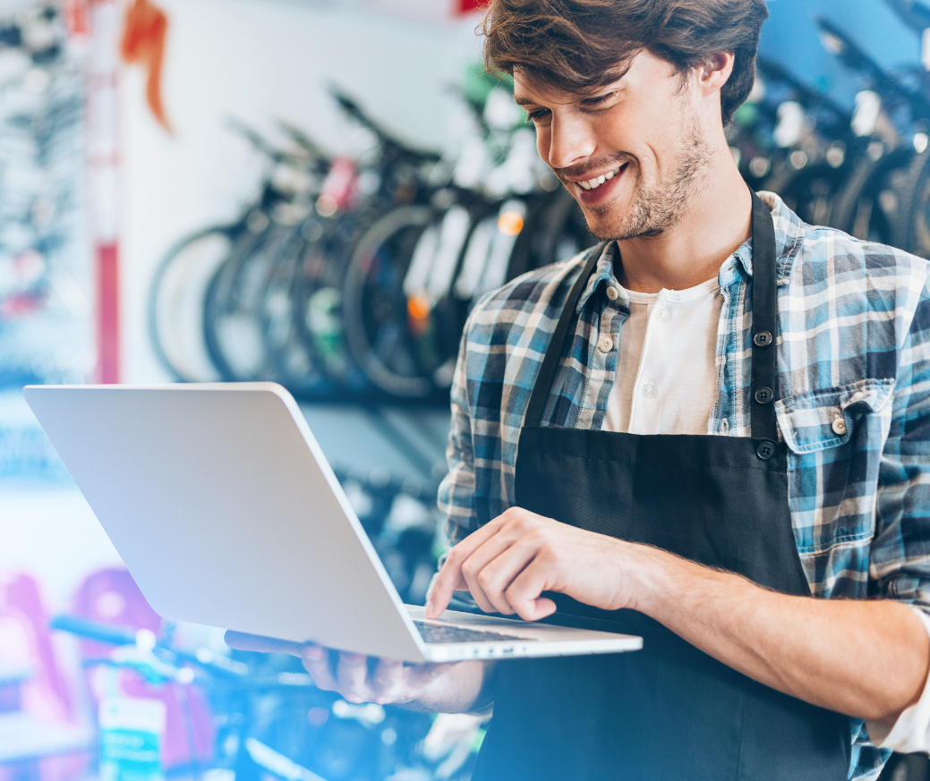 Business owner viewing NetSuite's pricing model on a laptop.