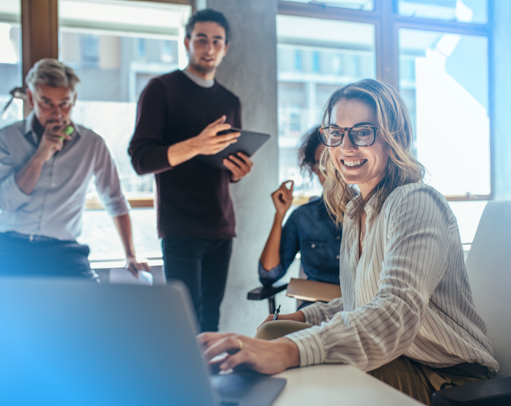 Female entrepreneur showing colleagues CloudConnect and NetSuite's advanced customer support.