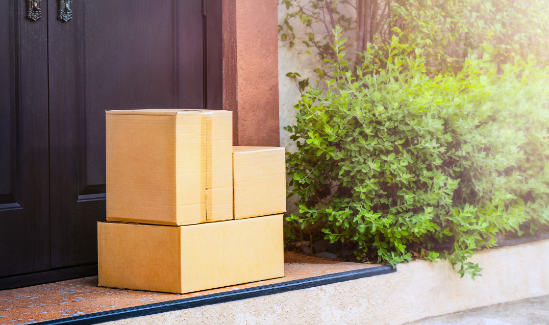 Cardboard boxes on the doorstep showcasing efficient packing optimization for timely deliveries.