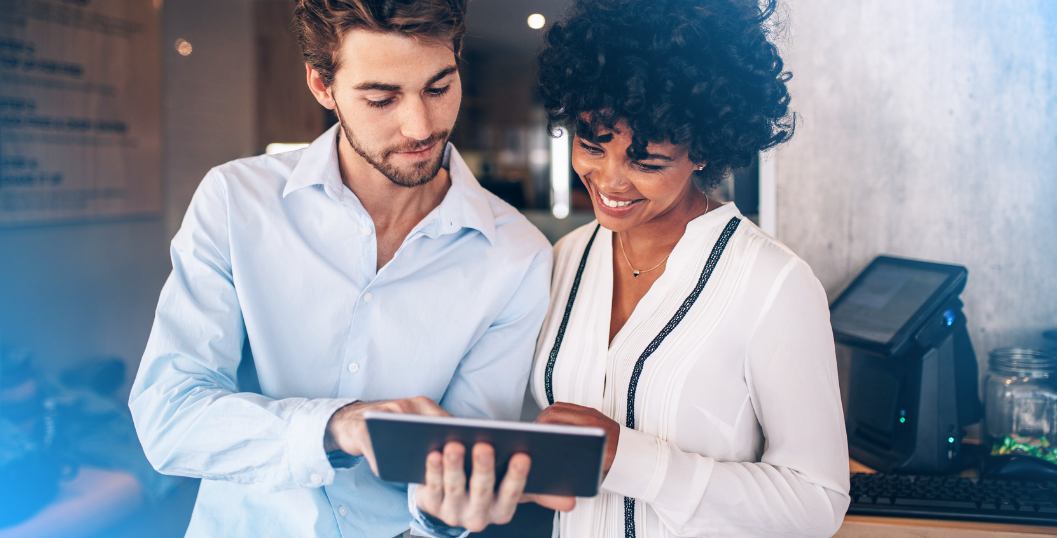 Business workers viewing CloudConnect's NetSuite pricing on a tablet.